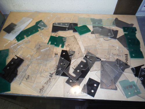PILE OF PLASTIC AND METAL TEMPLETS FOR WEINIG MOLDING KNIVES PROFILES