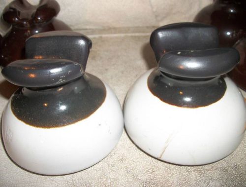Pair (2) insulators porcelain 5&#034; wide dark w\cream base saddleback stamped v nos for sale