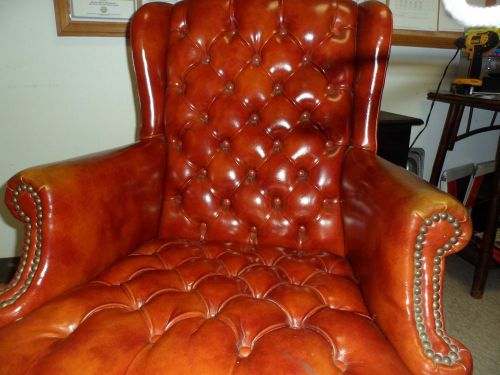 High End Tufted leather nail head trim wing chair.