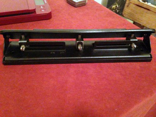 Three hole punch with adjustable width in inches; clean and sturdy, lightly used