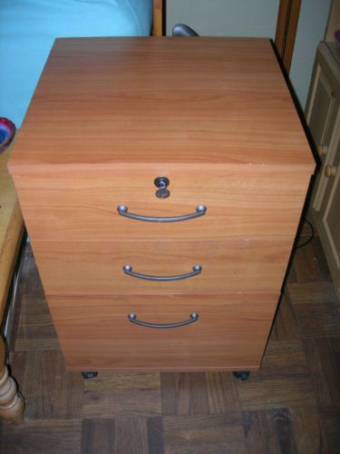 WOOD FILING CABINET, THREE DRAWERS,  LOCK W/KEY, CASTERS. NYC PICKUP ONLY