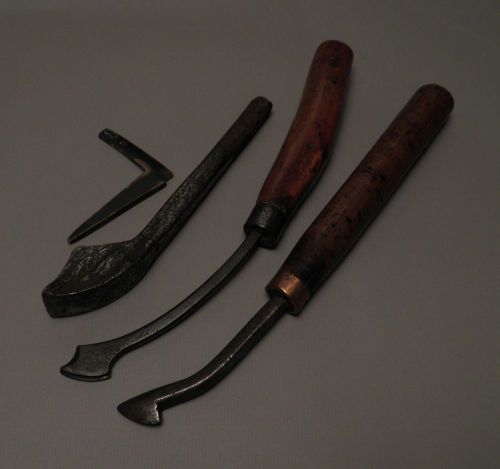 These are a lot of 3 iron and 1 brass antique leather bookbinding tools