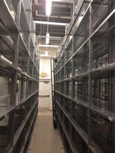 Used metal shelving with sliding ladders for sale