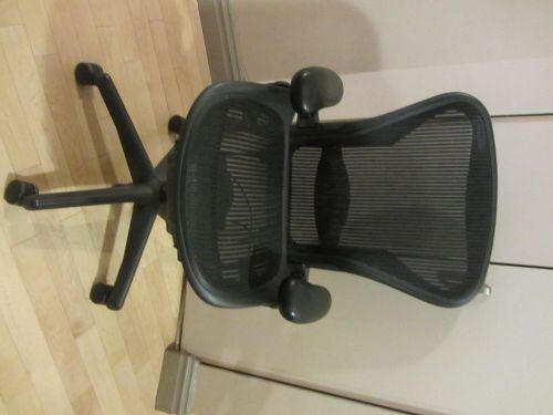 Herman Miller black ergonomic desk chair, armrests, seat height, and seat tilt.