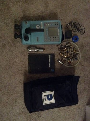 Druck DPI 610 Pressure Calibrator includes case, charger, manual, and fittings