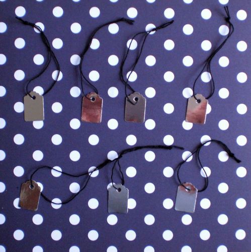 Silver gloss strung jewellery tag/white back/black string. Size 23x15mm. Pack/50