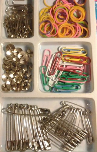 office supplies mix safety pins, thumbtacks, paper clips, color rubber bands .