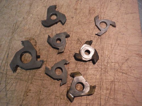 PILE OF CARBIDE TIPPED INDUSTRIAL WOOD SHAPER CUTTERS