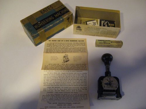Bates numbering machine in original box with instructions