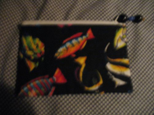A 5 INCH X 7 INCH ZIP BAG WITH FISH PRINT INSIDE AND OUT