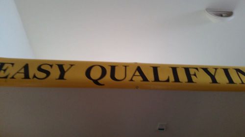 Banner:  EASY QUALIFYING approx.  10” x 80” yellow banner