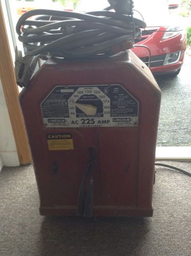 PAIR OF LINCOLN ARC WELDERS 225 AMP AC AND AC/DC WITH 2 VINTAGE WELDING MASKS