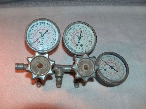 THREE VINTAGE ROBINAIR GAUGES MOUNTED WITH VALVE HANDLES