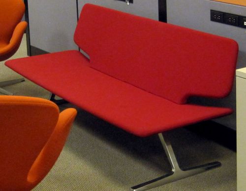 Scandinavian armless &#034;gondola&#034; sofa, red upholstery, aluminum pedestal legs