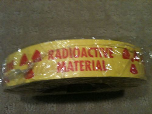 yellow tape &#039;radioactive material&#039; roll new with rad symbol
