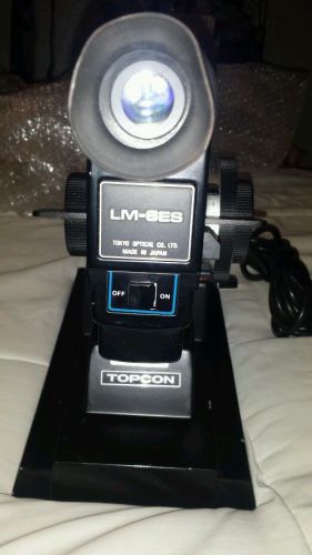 Lensometer Topcon LM-6E missing plastic in axis wheel but works fine.