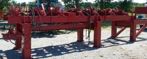 Hydraulic hourglass roller sorting deck for log merchandizing system