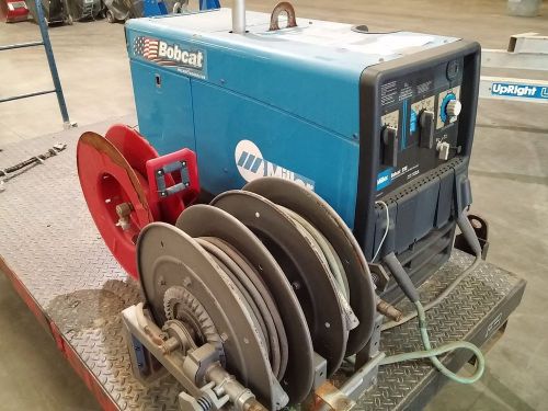 Miller bobcat 250 cc/cv ac/dc welder rig with platform, reels, and cables for sale