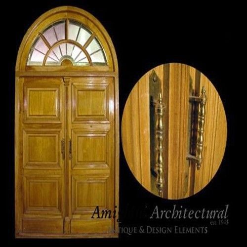 Double entry arched door with stained glass transom.
