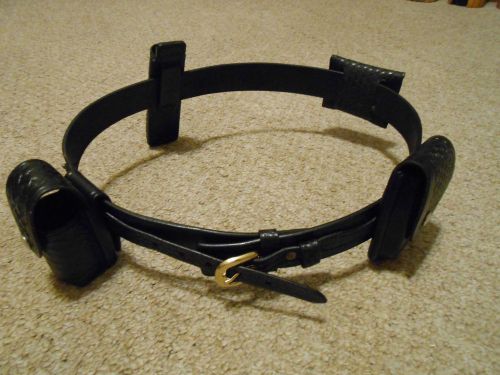 BLACK LEATHER POLICE BELT WITH HANDCUFF HOLDER , MACE HOLDER AND MORE .