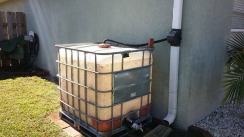 TOTE 250 GALLON PLASTIC CONTAINER WITH METAL FRAME FOR LIQUID STORAGE (USED)