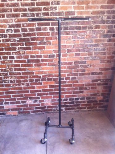 Retail store fixture vintage rolling clothing rack single bar for sale