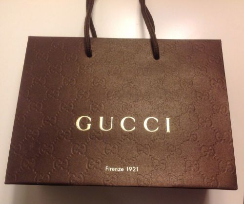 Embossed paper gift, shopping bag from Gucci designer store. Brown GOLD logo 1
