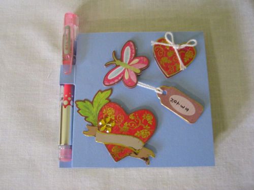 Covered 3x3 post-it note pad with pen