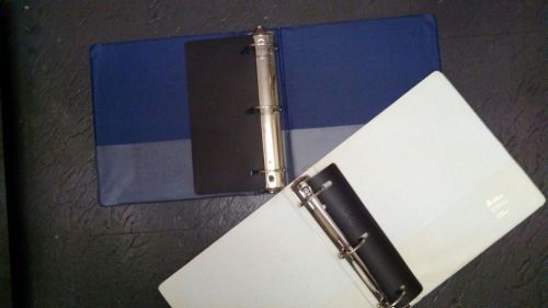 Cleaning Out: 2 Used 2.5 or 2 inch Three Ring Binders 1 Blue 1 White