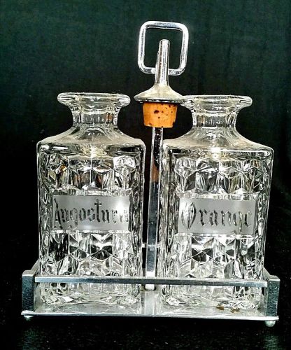 Fostoria American Angostura and Orange Clear Bitter Decanters in Chrome Carrier
