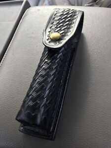 GOULD &amp; GOODRICH BLACK LEATHER BASKETWEAVE BATON HOLDER WITH BRASS COLORED SNAP.