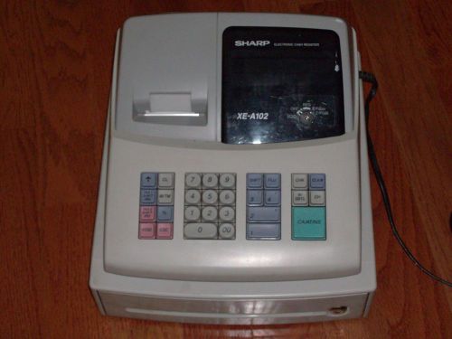 electronic cash register the brand a Sharp XE-A102 the color is gray and white