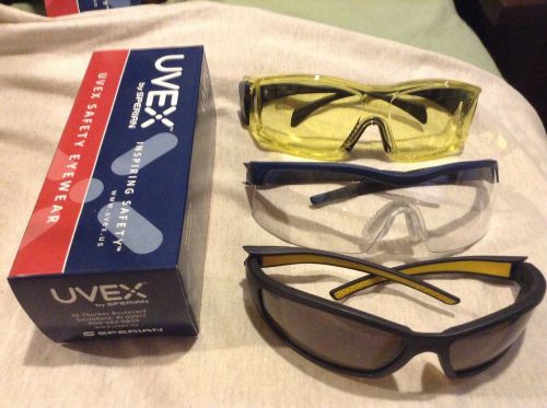 Uvex safety glasses. new in boxes. 3 pr. yellow otg, clear and shaded. unisex. for sale