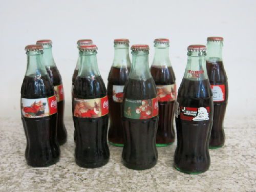 9 MIXED UNOPENED COCA-COLA COMMEMORATIVE CHRISTMAS 8 OZ. BOTTLES