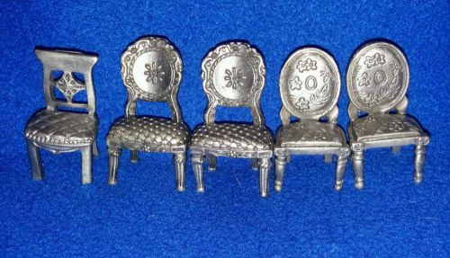 Mini pewter card holder chairs.
