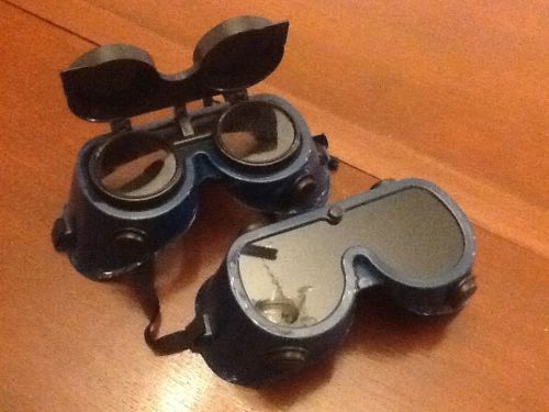 Two pairs welding goggles, one with flip down lenses and one solid, soft frames