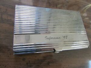 Brass business card container with Inforama 97 inscription classy but needs a cl