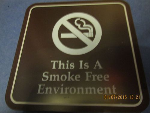 This s a smoke free environment sign brown