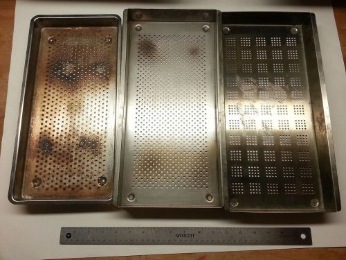 Three stainless steel perforated sterilization trays for sale