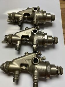 Three Binks model 61 spray guns