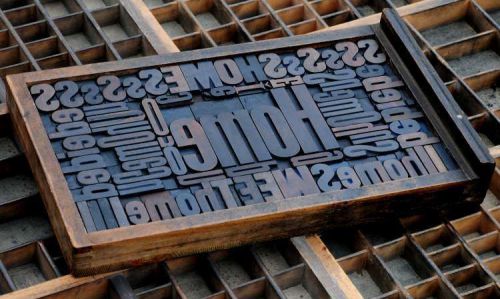 Collage &#034;HOME&#034; made of letterpress wood type characters in antique drawer old