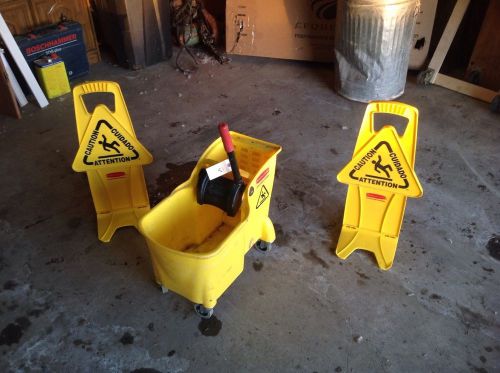 Commercial mop bucket with 2 caution signs