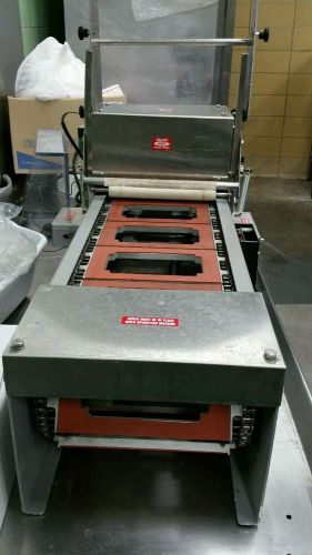 Anchor, Automatic Commercial Sandwich clear film lidder for sandwich triangles.