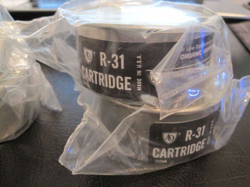 --- 4 sealed American Optical round R-31 organic vapors respirator cartridges