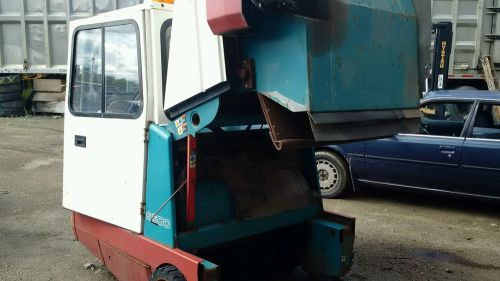 Tennant 6100 ride on sweeper gas powered. runs drives shaker broke. for sale