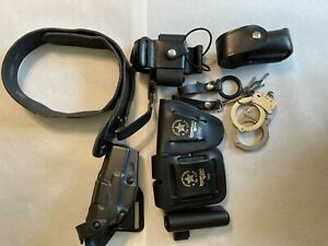 POLICE OFFICER LOT BELT HANDCUFFS WITH KEYS, HOLSTERS, MISC HOLDERS