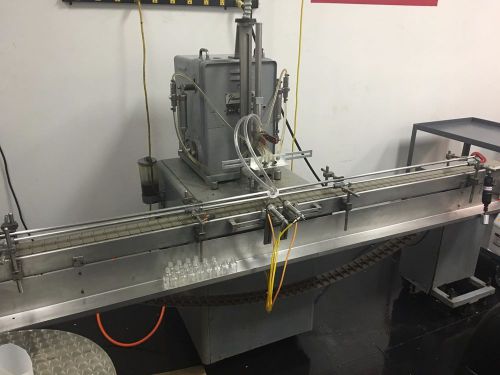 Filamatic automated filler, wrap around labeler, and rotating transfer table for sale