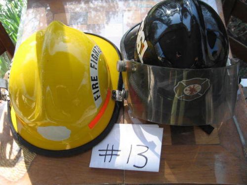 1 yellow  cairns  fire  helmet and 1 black cairns firehelmet for sale