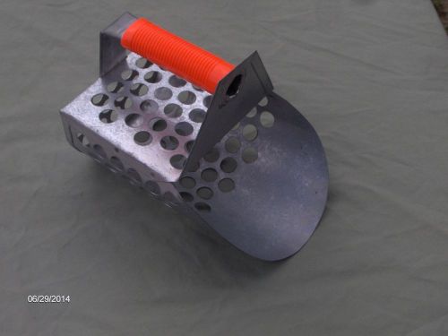 All METAL SCOOP WITH 5/8 inch HOLES all over it!  Rubber coated handle.