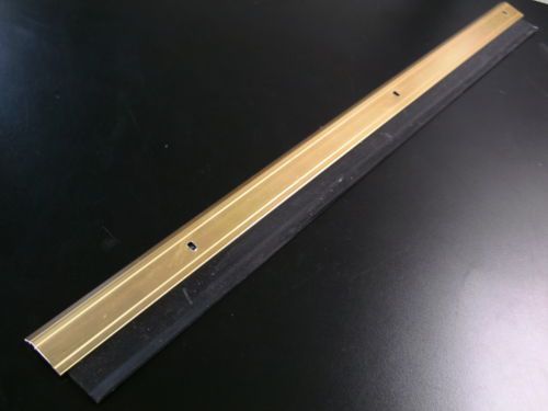 Door sweep gold/broze 23.75&#034; long anodized aluminum w/ 2&#034; double rubber seal vgc for sale